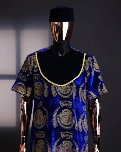 An “isiagu” gold, blue with matching fringe details, short sleeve, hat and velvet pant African traditional native.