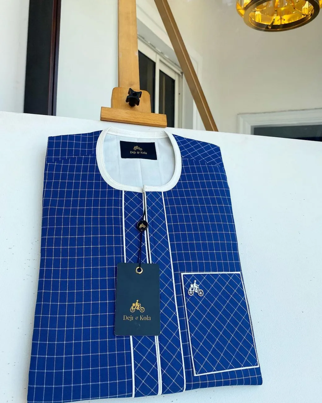 An ivory and blue check kaftan with an ivory-layered front section is a traditional African kaftan
