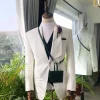 An Ivory White “Wedding In The Jungle” shawl lapel tuxedo suit