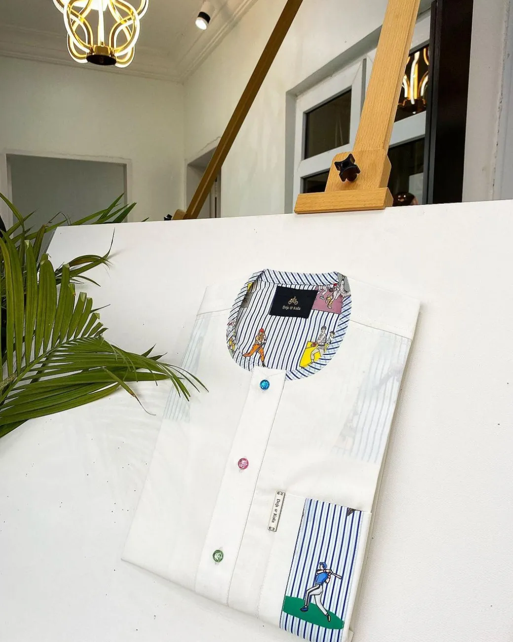 An Ivory white African kaftan, paisley detailing, Swarovski buttons