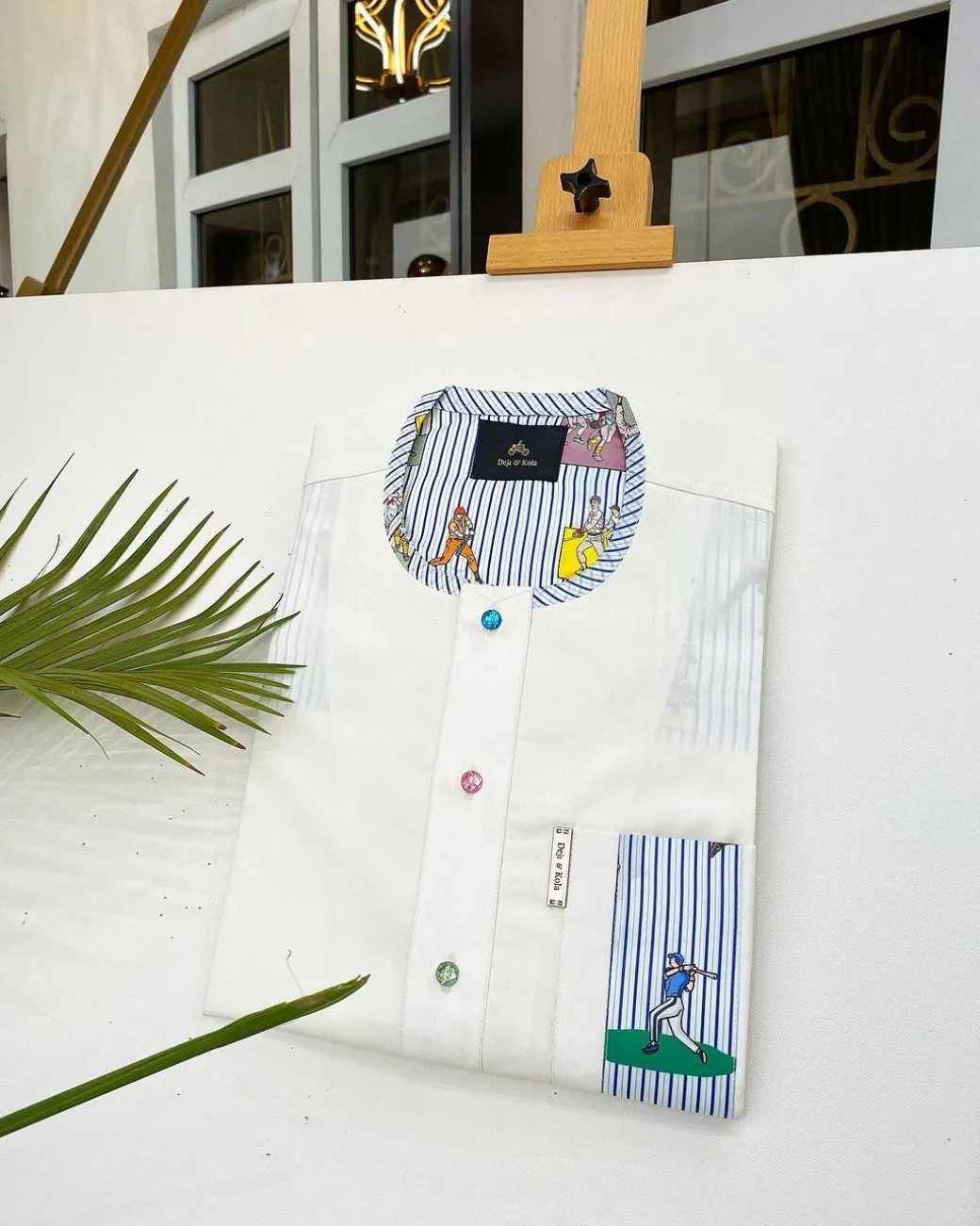 An Ivory white African kaftan, paisley detailing, Swarovski buttons