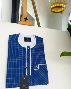 An ivory white and blue check, clear view transparent Swarovski buttons, front flap details African traditional senator kaftan native.