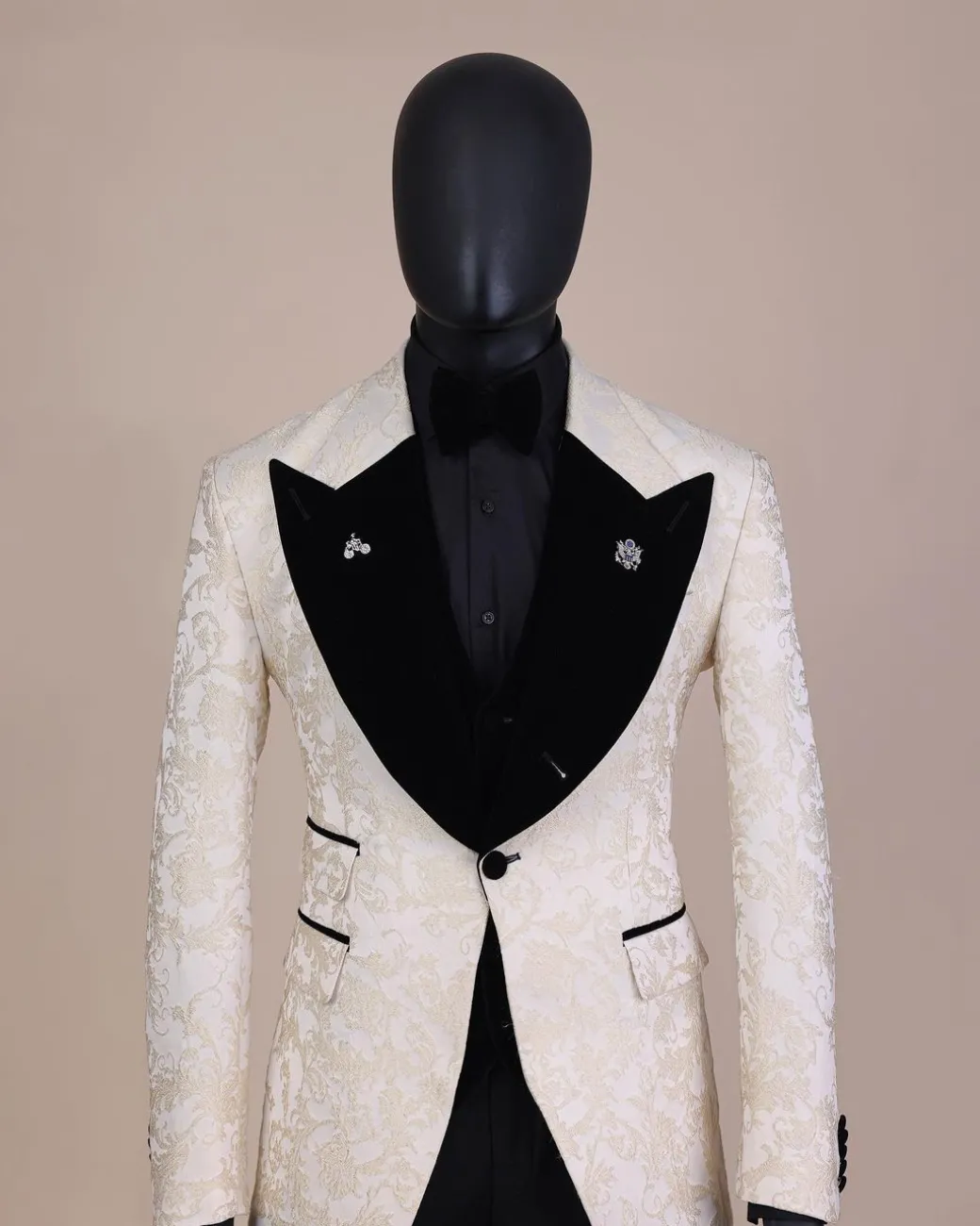 An Ivory white and Gold Floral patterned Peak lapel metallic jacquard tuxedo suit.