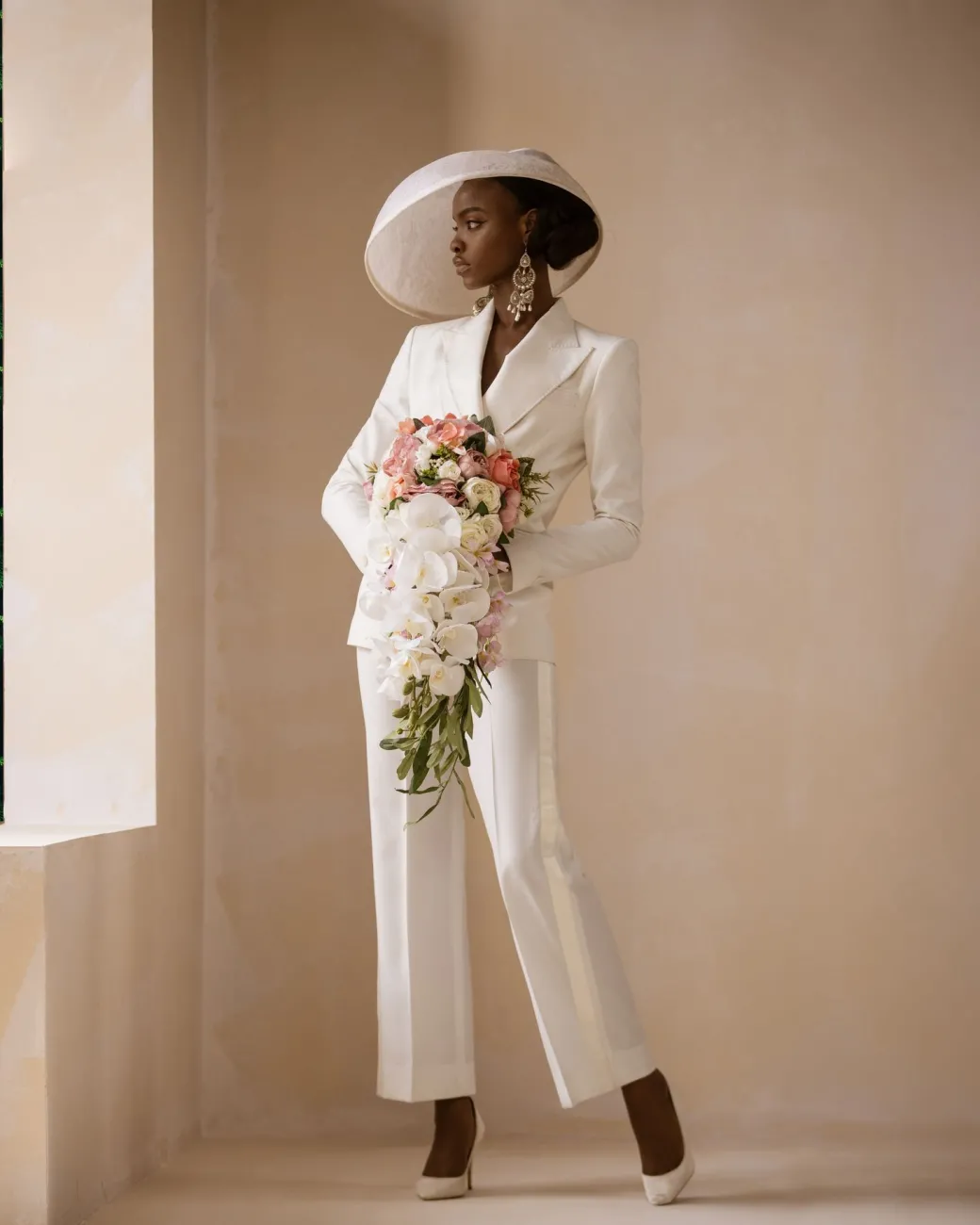 An Ivory White Cross Tuxedo Bridal Suit