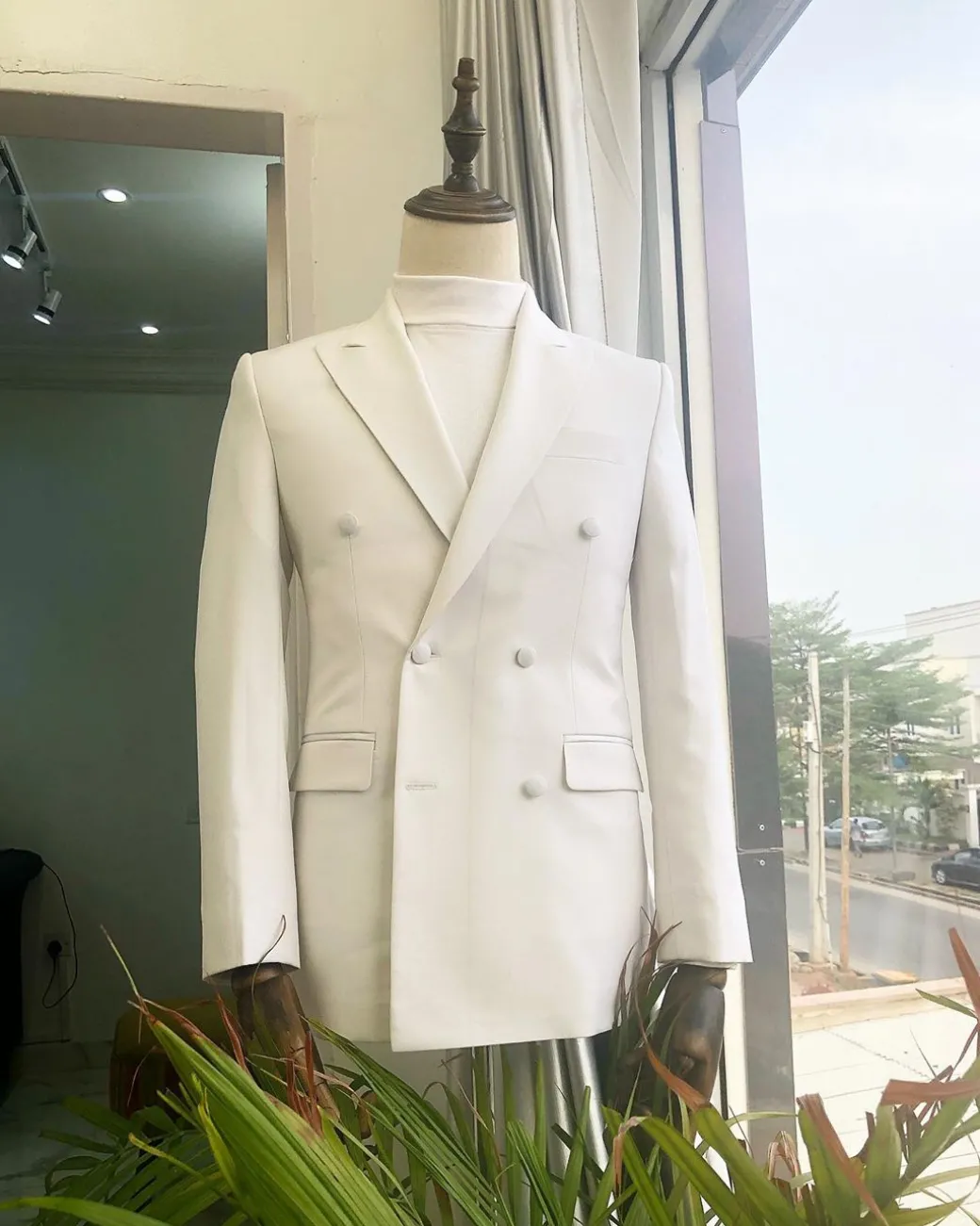 An Ivory White Double Breasted Peak Lapel Suit