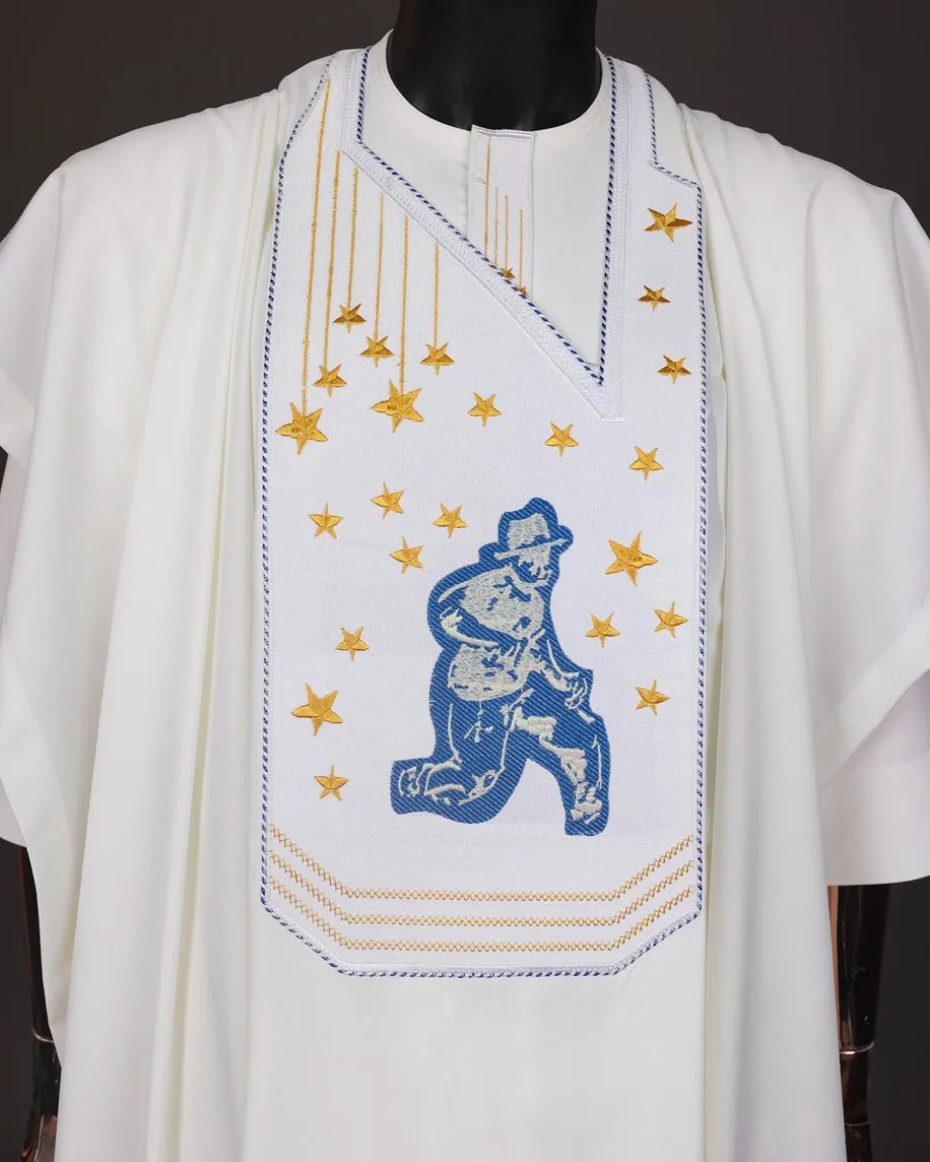 An Ivory white, dropping stars and bender knees metallic wire embroidery details agbada