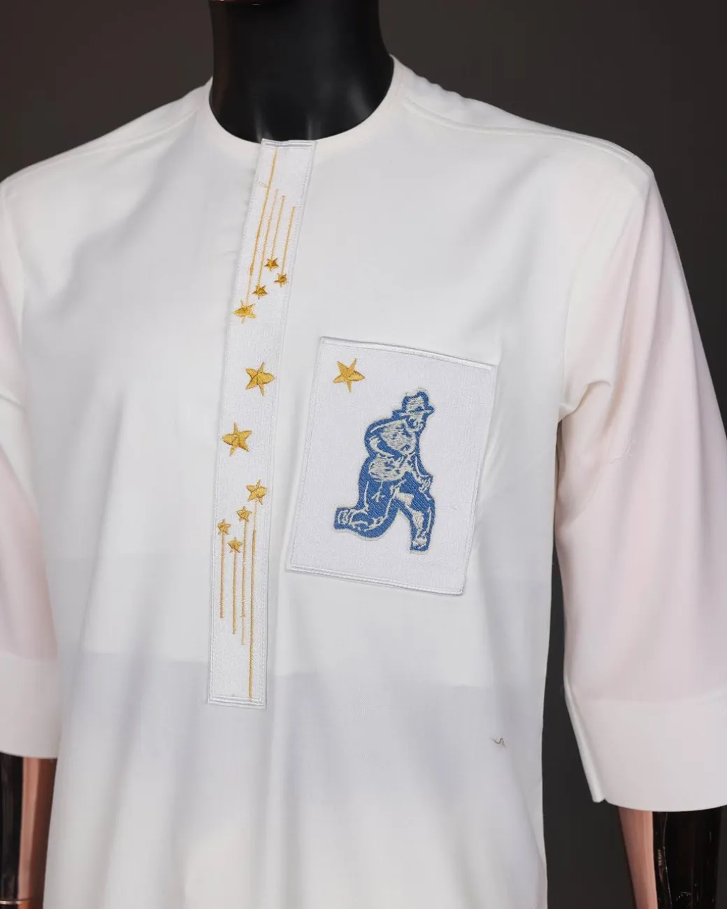 An Ivory white, dropping stars and bender knees metallic wire embroidery details agbada