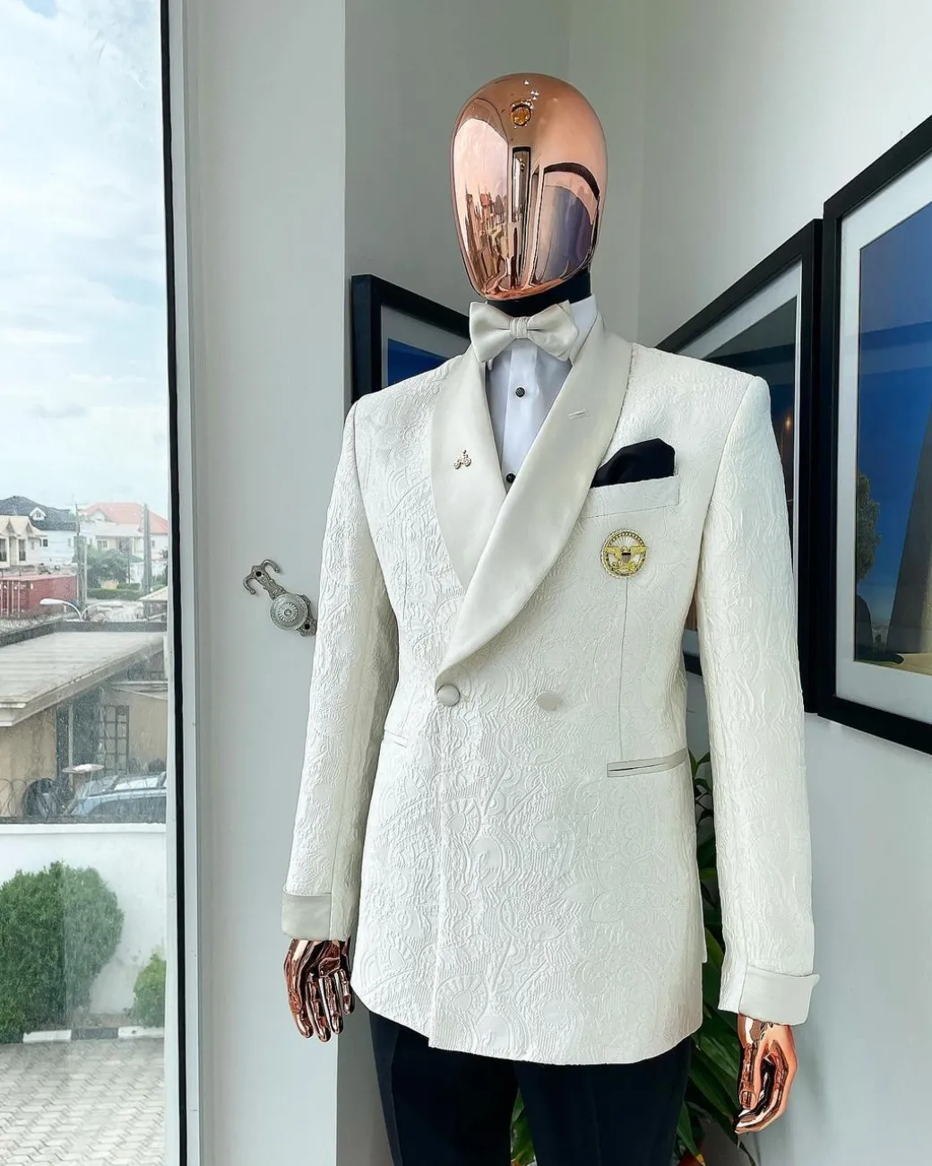 An ivory white Egyptian scritto pattern jacquard shawl lapel single button, double breasted Suit