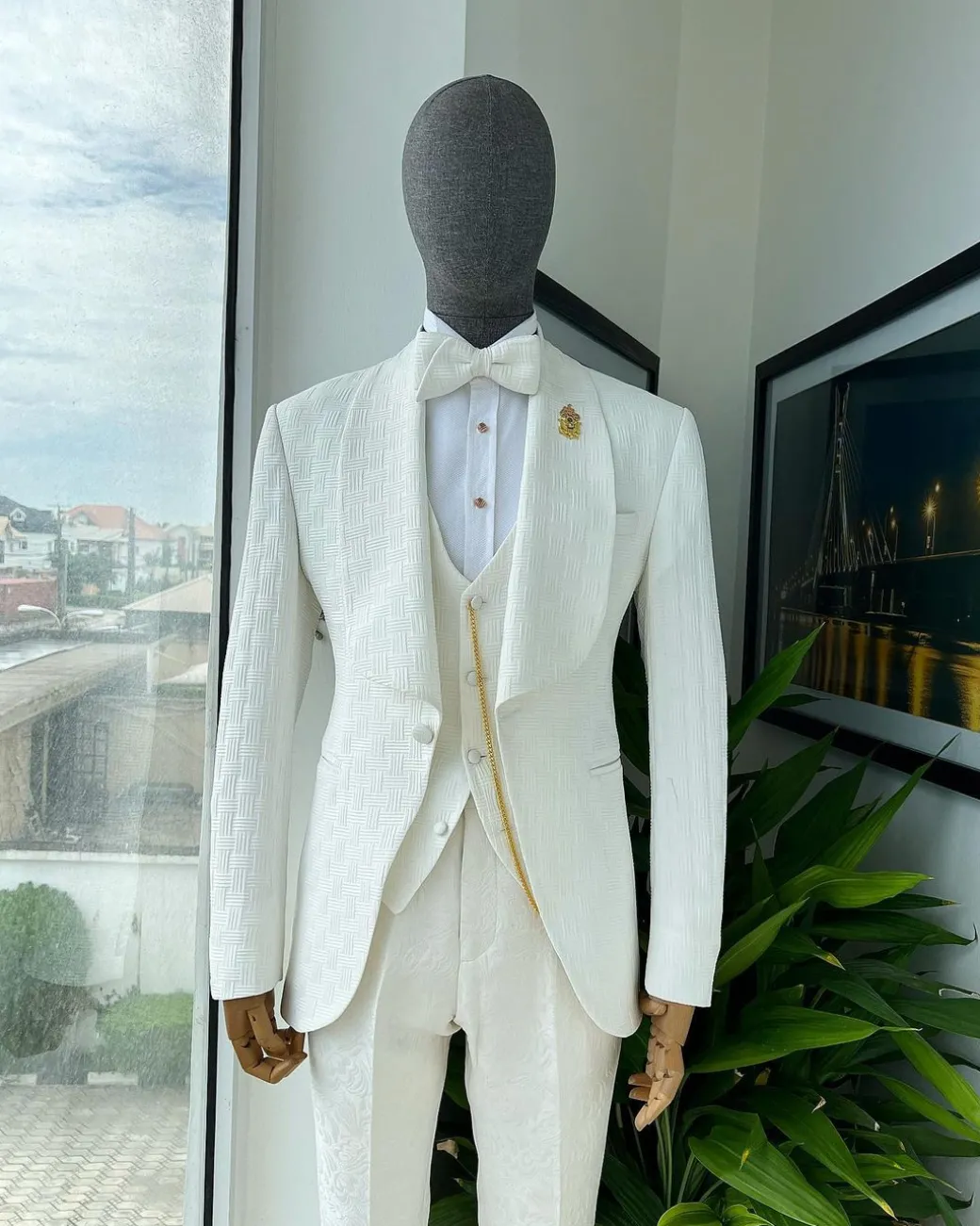 An ivory white, elastic, basket weave layered floral jacquard shawl lapel tuxedo suit.