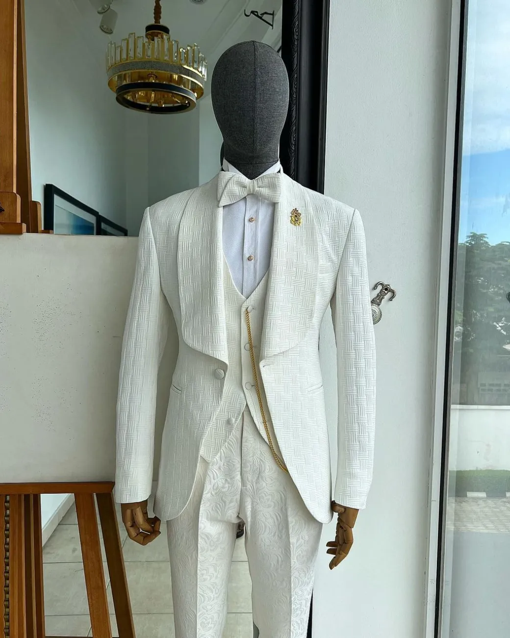 An ivory white, elastic, basket weave layered floral jacquard shawl lapel tuxedo suit.