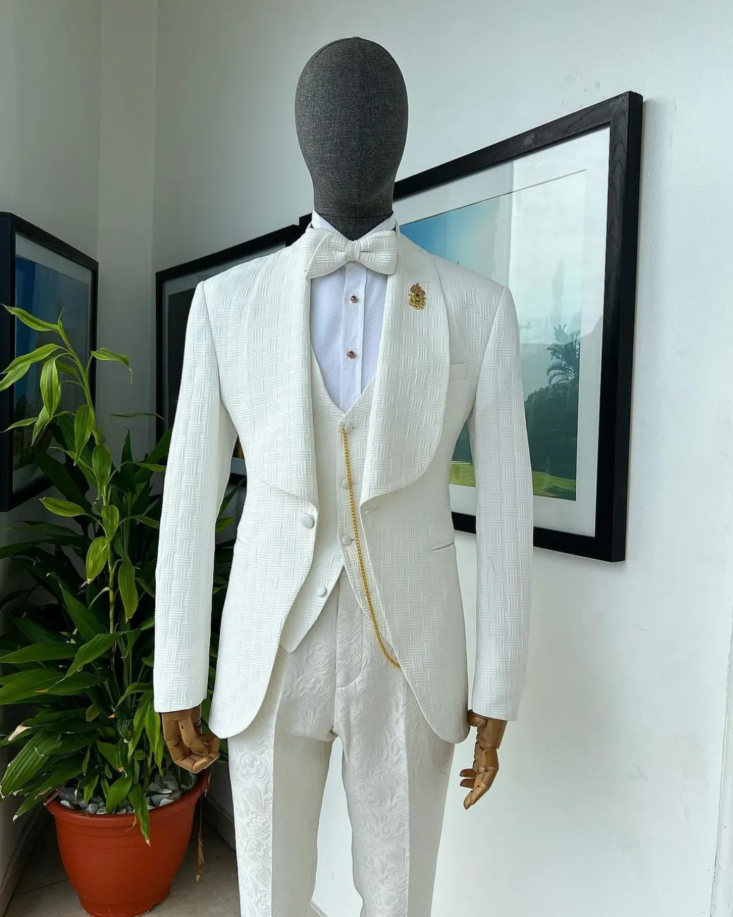 An ivory white, elastic, basket weave layered floral jacquard shawl lapel tuxedo suit.