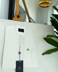 An ivory white embroidery front flap and edge embroidery cut detail African traditional senator kaftan native