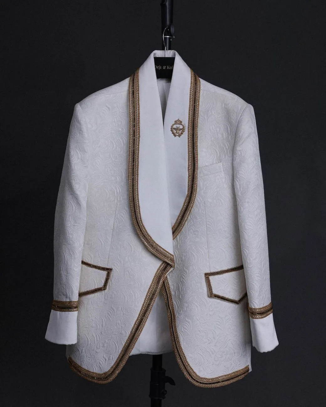 An ivory white floral Jacquard, gold trimmings, patch pocket shawl lapel tuxedo suit