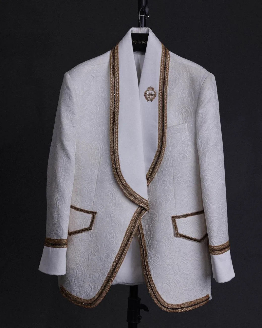 An ivory white floral Jacquard, gold trimmings, patch pocket shawl lapel tuxedo suit