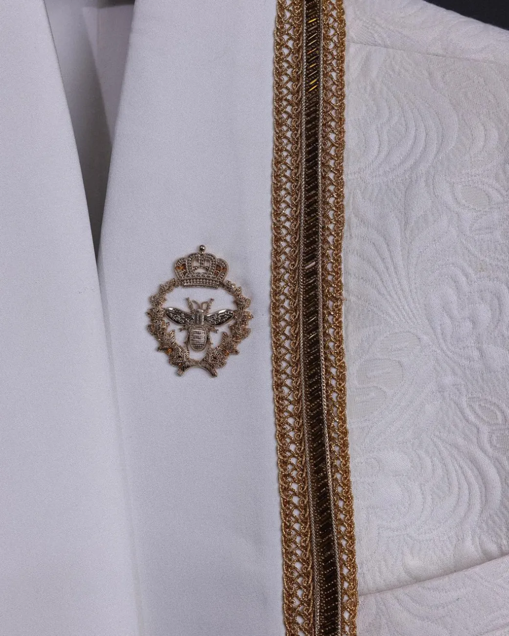 An ivory white floral Jacquard, gold trimmings, patch pocket shawl lapel tuxedo suit