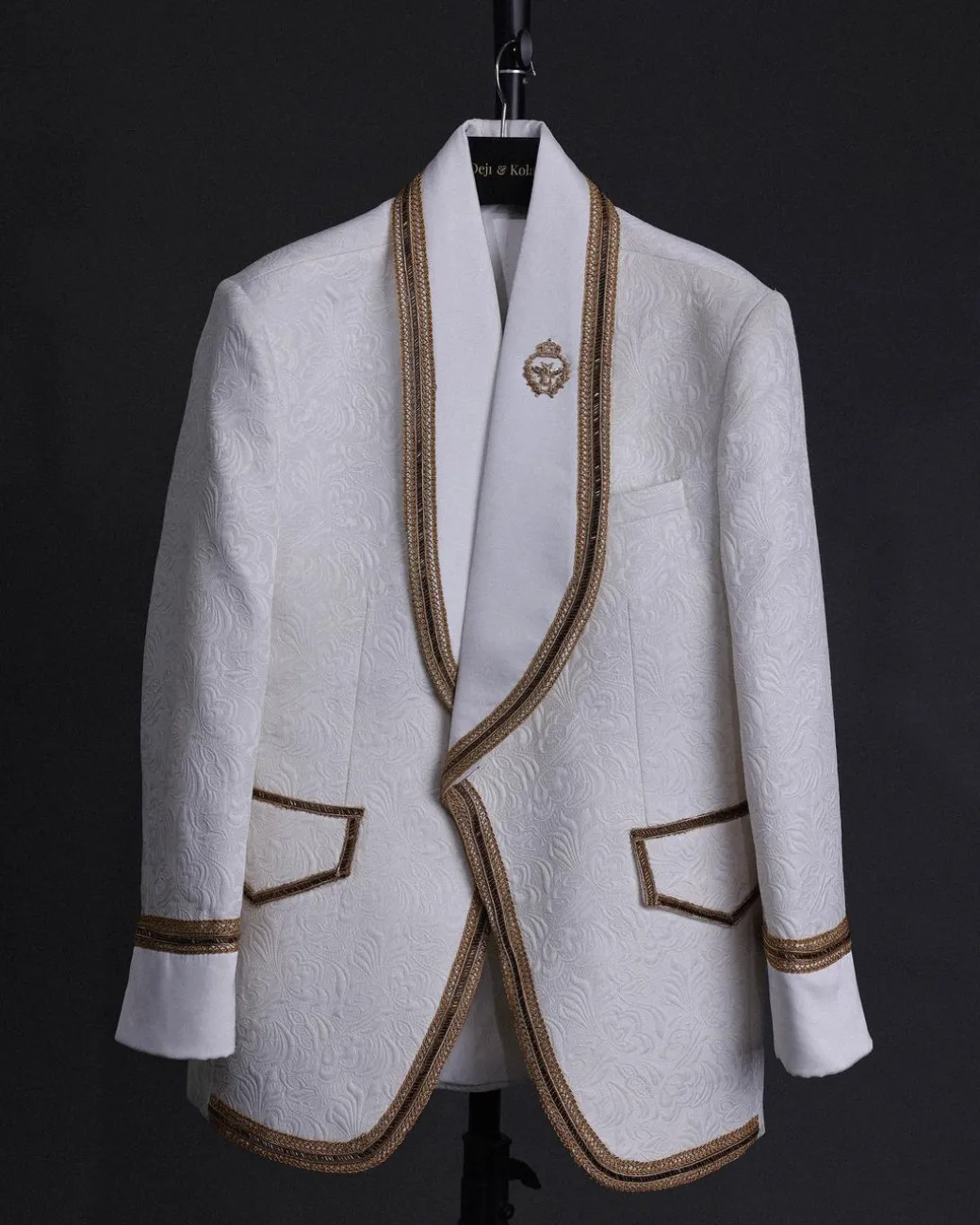 An ivory white floral Jacquard, gold trimmings, patch pocket shawl lapel tuxedo suit