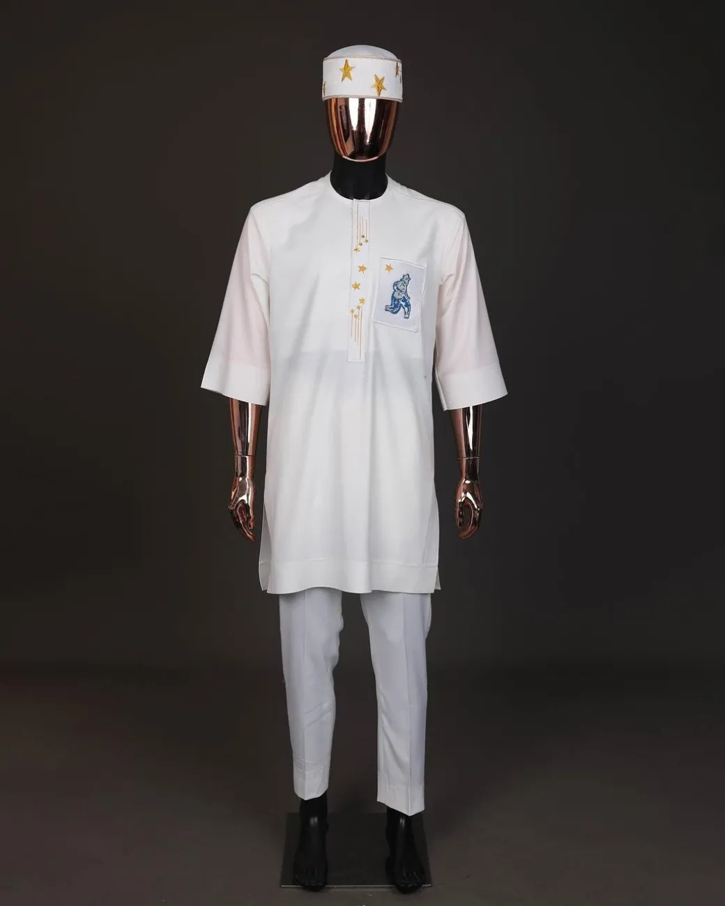An Ivory white, front flap with dropping star embroidery , 3/4 sleeve African senator kaftan native.
