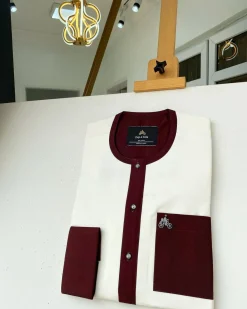 An Ivory white kaftan with a burgundy mix flap, pocket, and cuff design African Kaftan