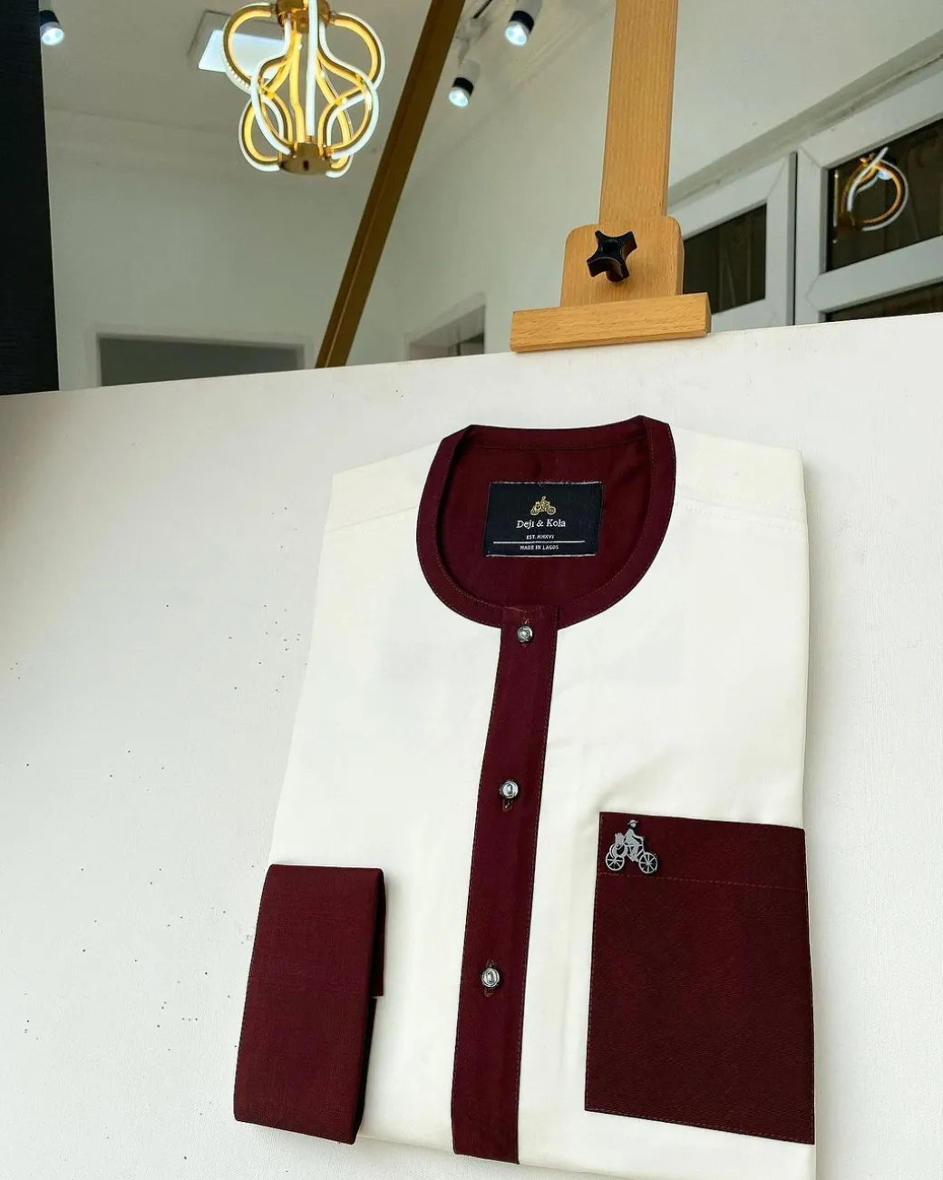 An Ivory white kaftan with a burgundy mix flap, pocket, and cuff design African Kaftan