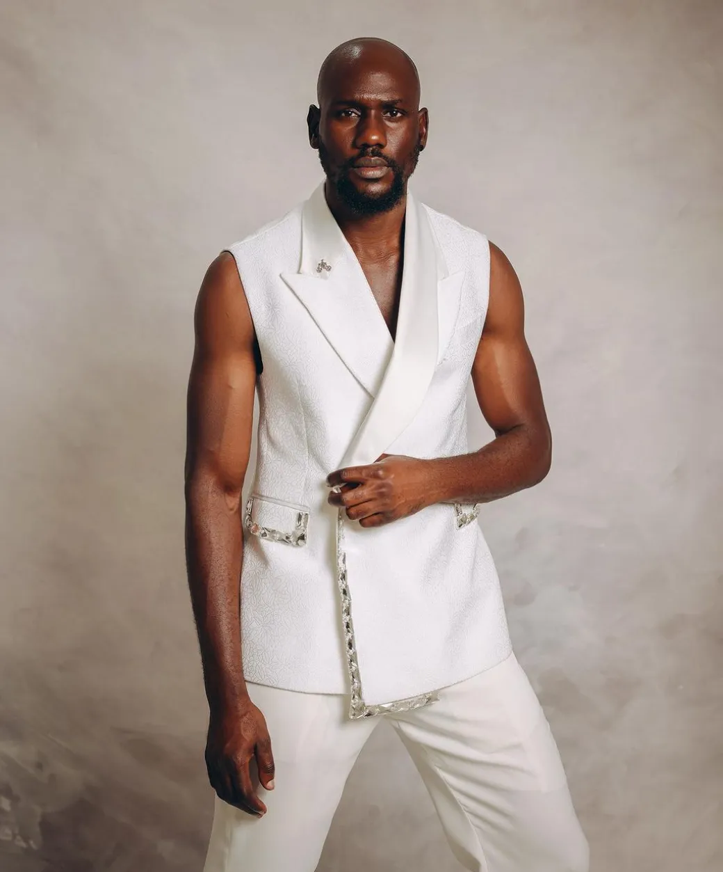 An Ivory White Monochrome “Jilted” Trio Lapel Armless Jacket With Swarovski Crystal Stone Details