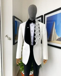 An Ivory white shawl lapel floral jacquard, satin taped lapel with floral details suit