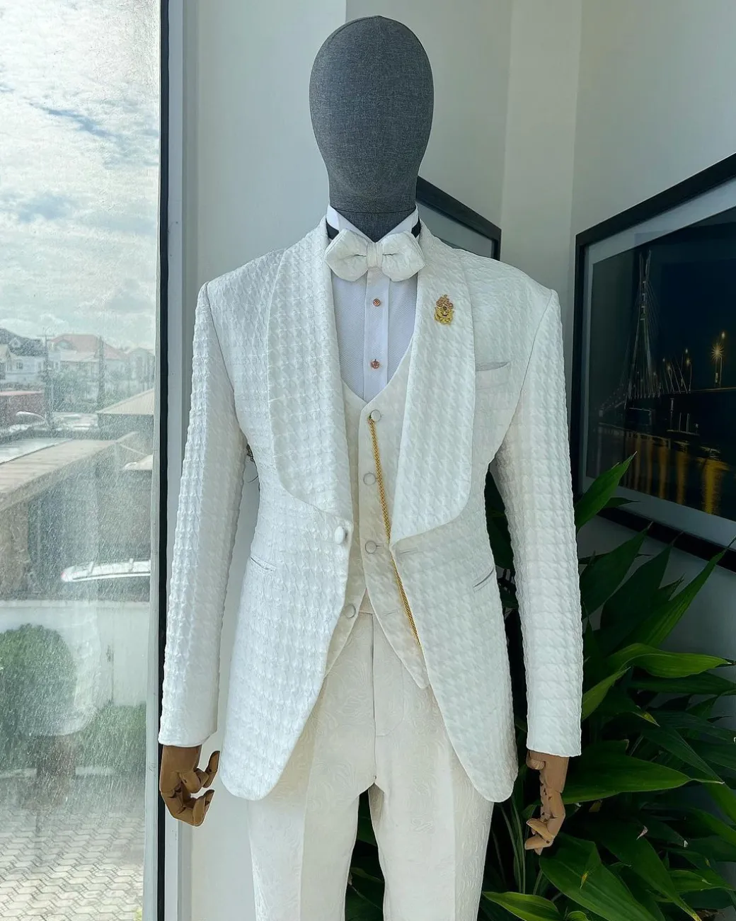 An Ivory white, swollen floral jacquard shawl lapel tuxedo suit.