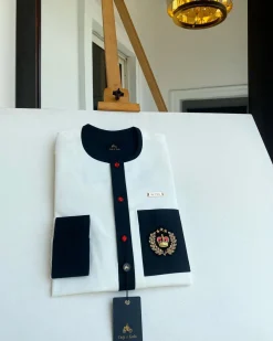 An Ivory white with a black flap, red detail button and royalty badge African Kaftan and Sokoto