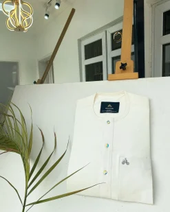 An Ivory white with a matching rainbow-shaded glass button African Kaftan