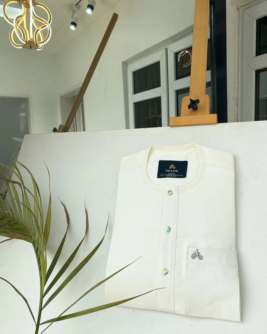 An Ivory white with a matching rainbow-shaded glass button African Kaftan