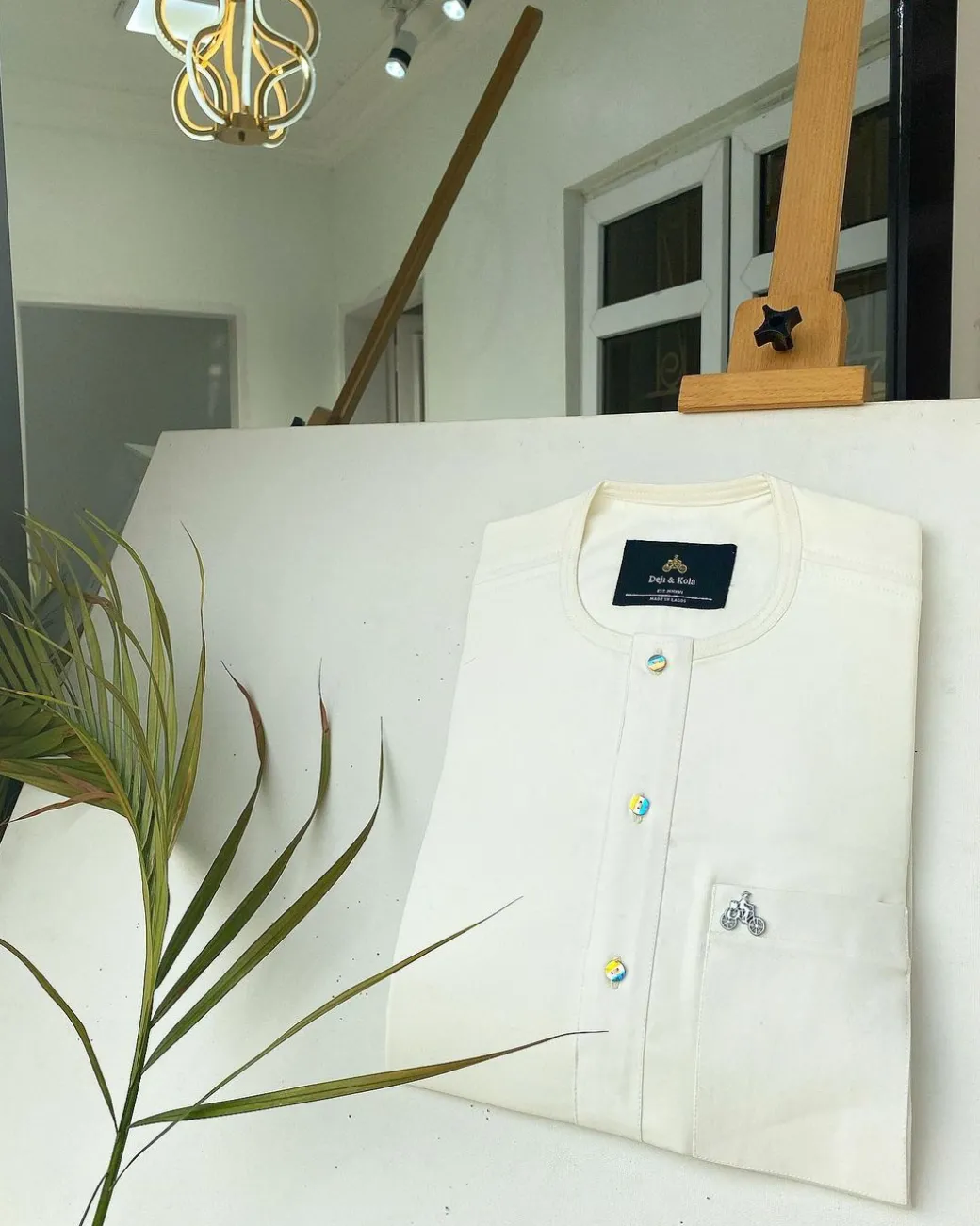 An Ivory white with a matching rainbow-shaded glass button African Kaftan