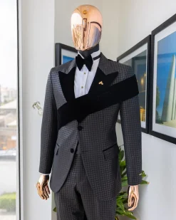 An “Octopus” black inverted square patterned jacquard tuxedo with left strap black velvet peak lapel suit