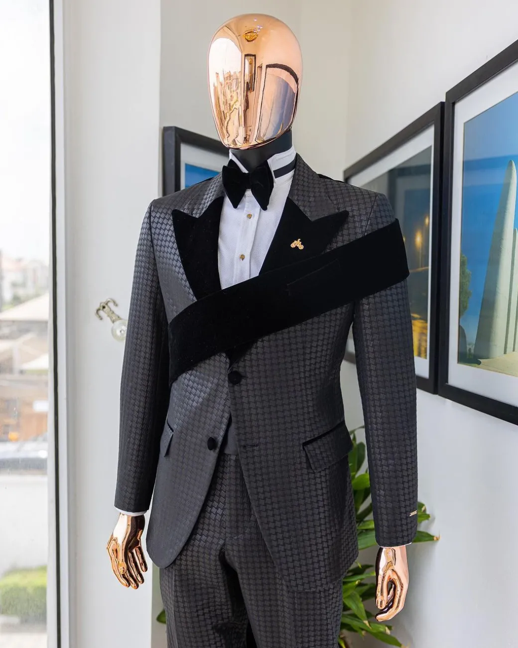 An “Octopus” black inverted square patterned jacquard tuxedo with left strap black velvet peak lapel suit