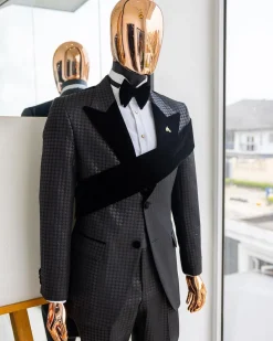 An “Octopus” black inverted square patterned jacquard tuxedo with left strap black velvet peak lapel suit
