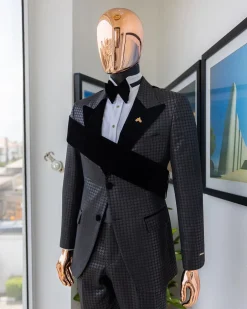 An “octopus” black inverted square patterned jacquard tuxedo with right strap black velvet peak lapel suit