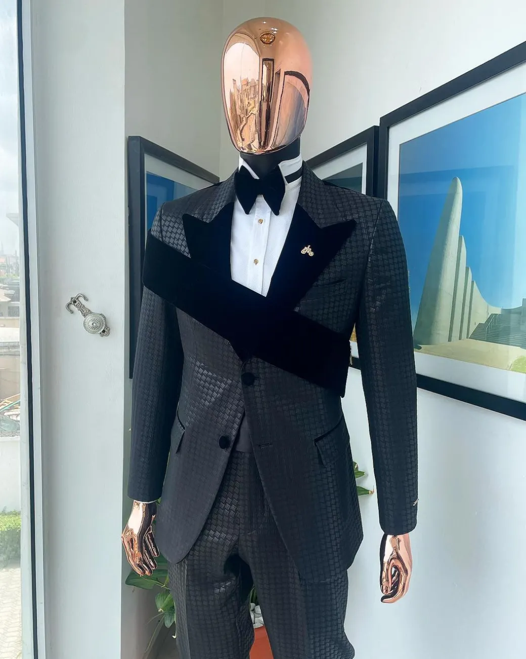 An “octopus” black inverted square patterned jacquard tuxedo with right strap black velvet peak lapel suit