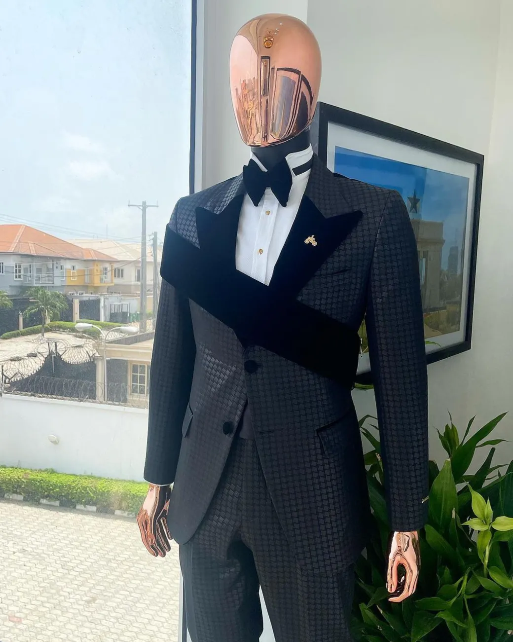 An “octopus” black inverted square patterned jacquard tuxedo with right strap black velvet peak lapel suit
