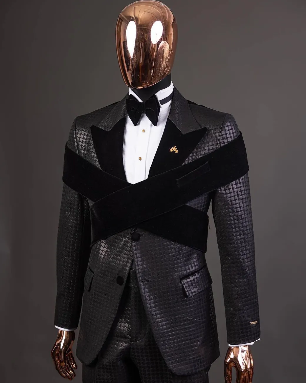 An “Octopus” black inverted square patterned metallic jacquard tuxedo with intersected black velvet peak lapel suit