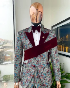 An “octopus” floral paisley tuxedo with left side strap mahogany red soaked Italian velvet peak lapel suit