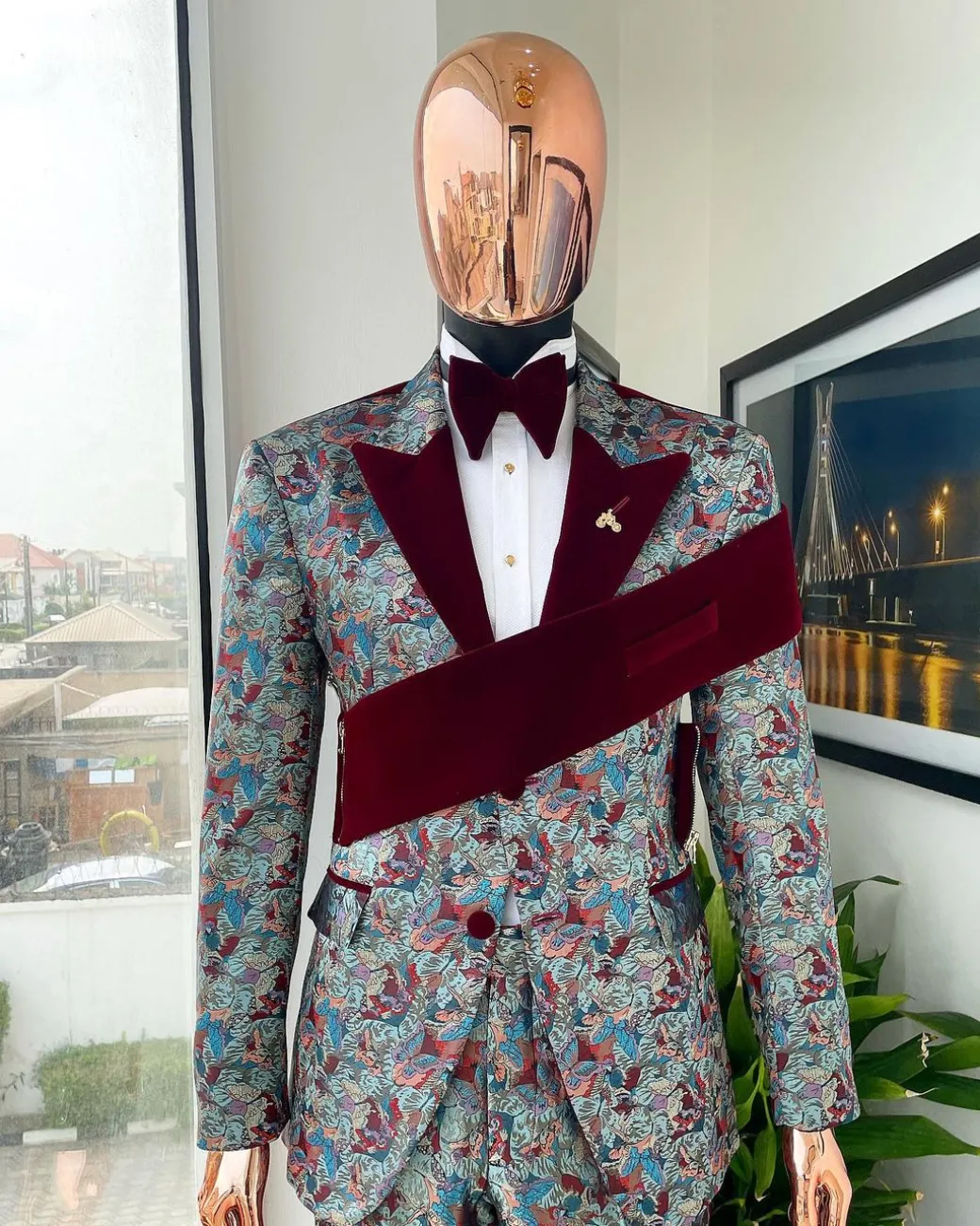 An “octopus” floral paisley tuxedo with left side strap mahogany red soaked Italian velvet peak lapel suit