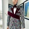 An “octopus” floral paisley tuxedo with right side strap mahogany red soaked Italian velvet peak lapel suit