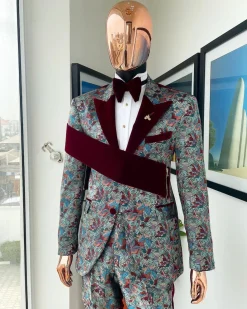 An “octopus” floral paisley tuxedo with right side strap mahogany red soaked Italian velvet peak lapel suit