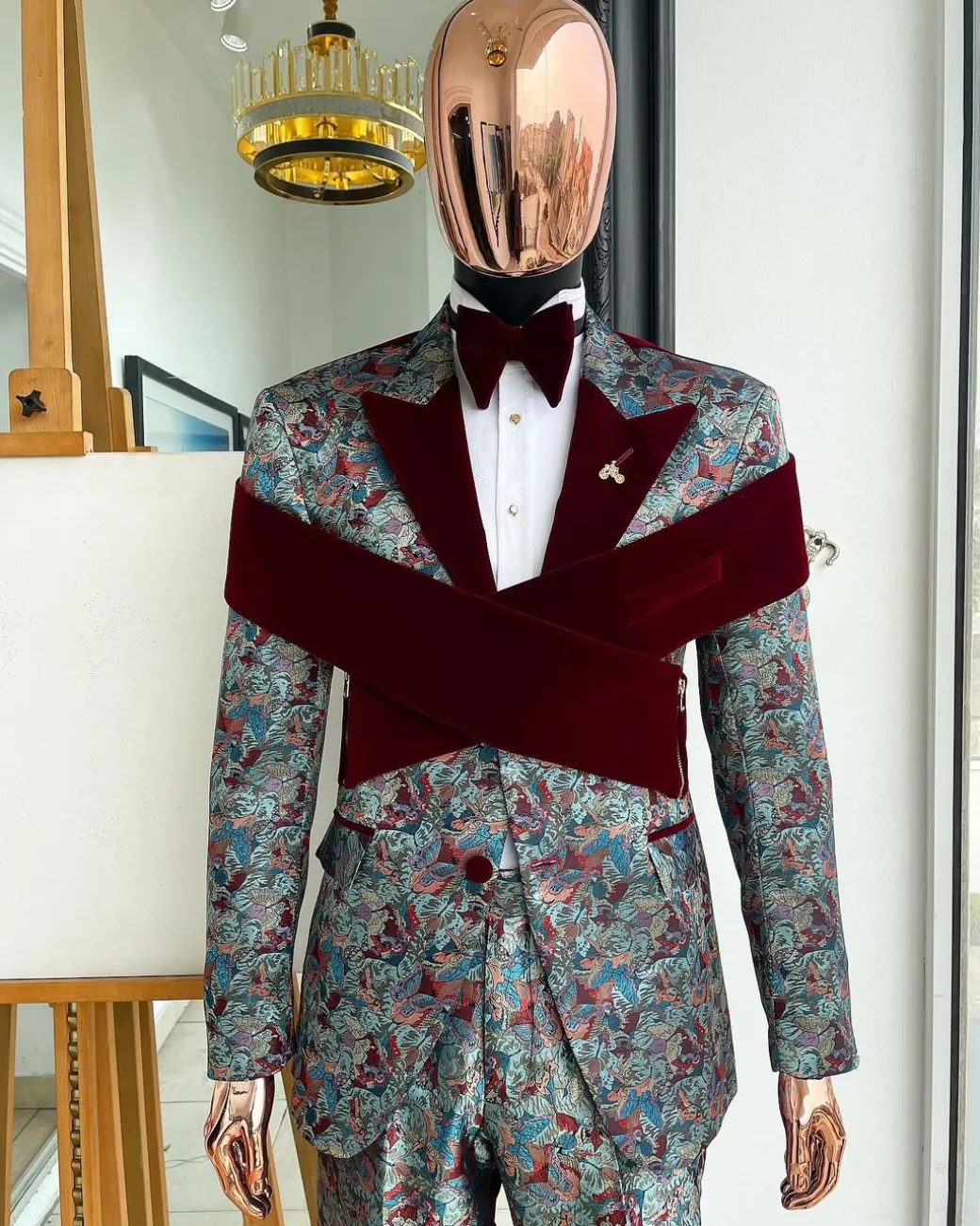 An “octopus” floral paisley tuxedo with intersected mahogany red soaked Italian velvet peak lapel suit