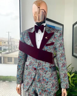 An “octopus” floral paisley tuxedo with right side strap mahogany red soaked Italian velvet peak lapel suit