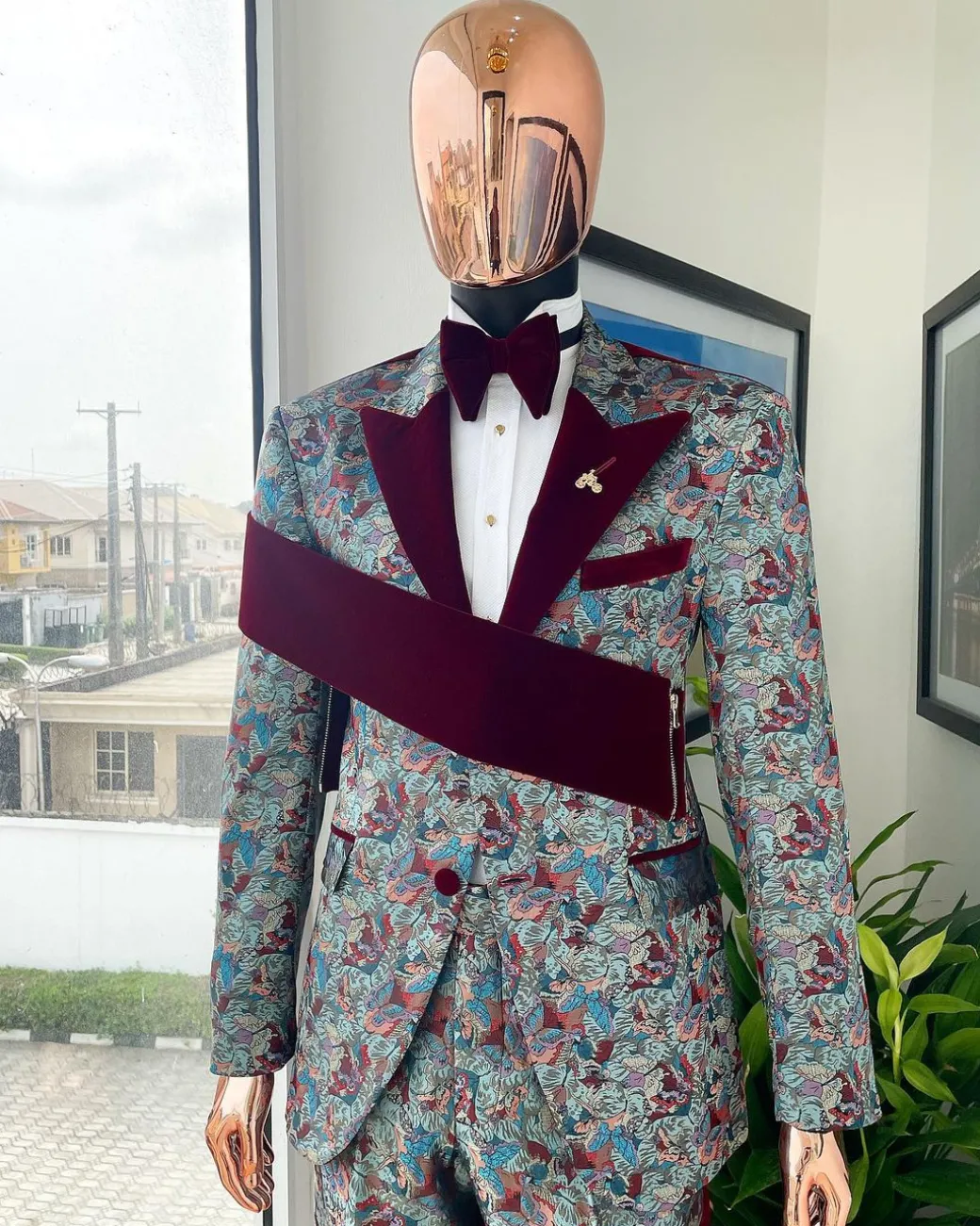 An “octopus” floral paisley tuxedo with right side strap mahogany red soaked Italian velvet peak lapel suit
