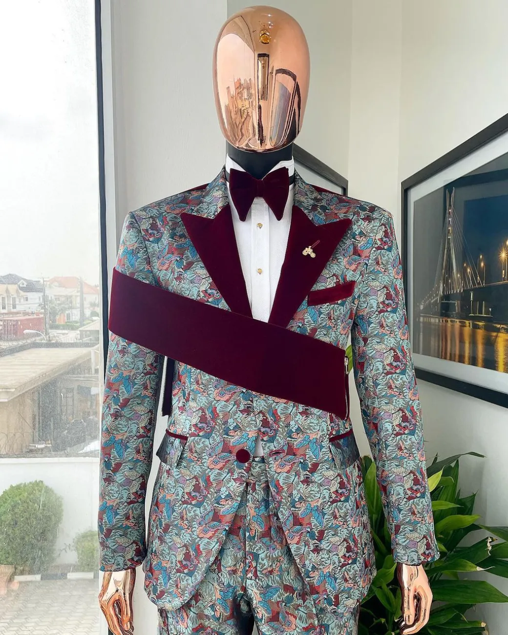 An “octopus” floral paisley tuxedo with right side strap mahogany red soaked Italian velvet peak lapel suit