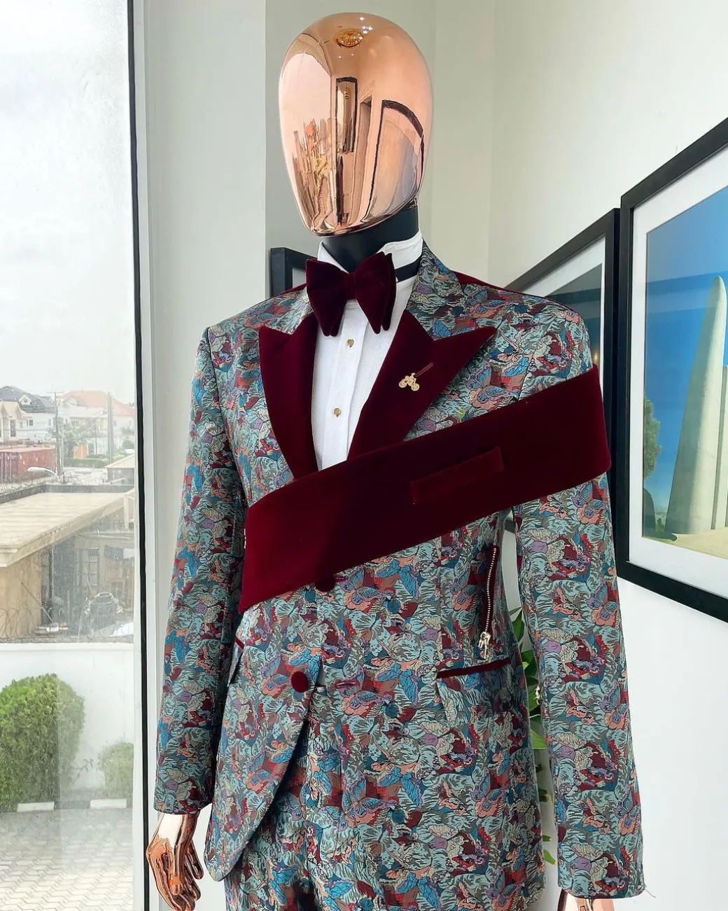 An “octopus” floral paisley tuxedo with left side strap mahogany red soaked Italian velvet peak lapel suit
