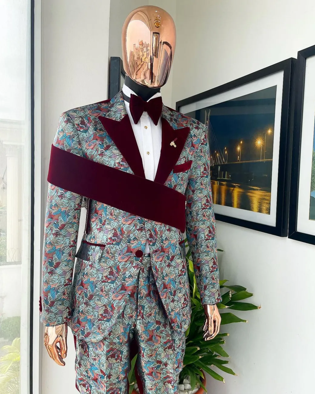 An “octopus” floral paisley tuxedo with right side strap mahogany red soaked Italian velvet peak lapel suit