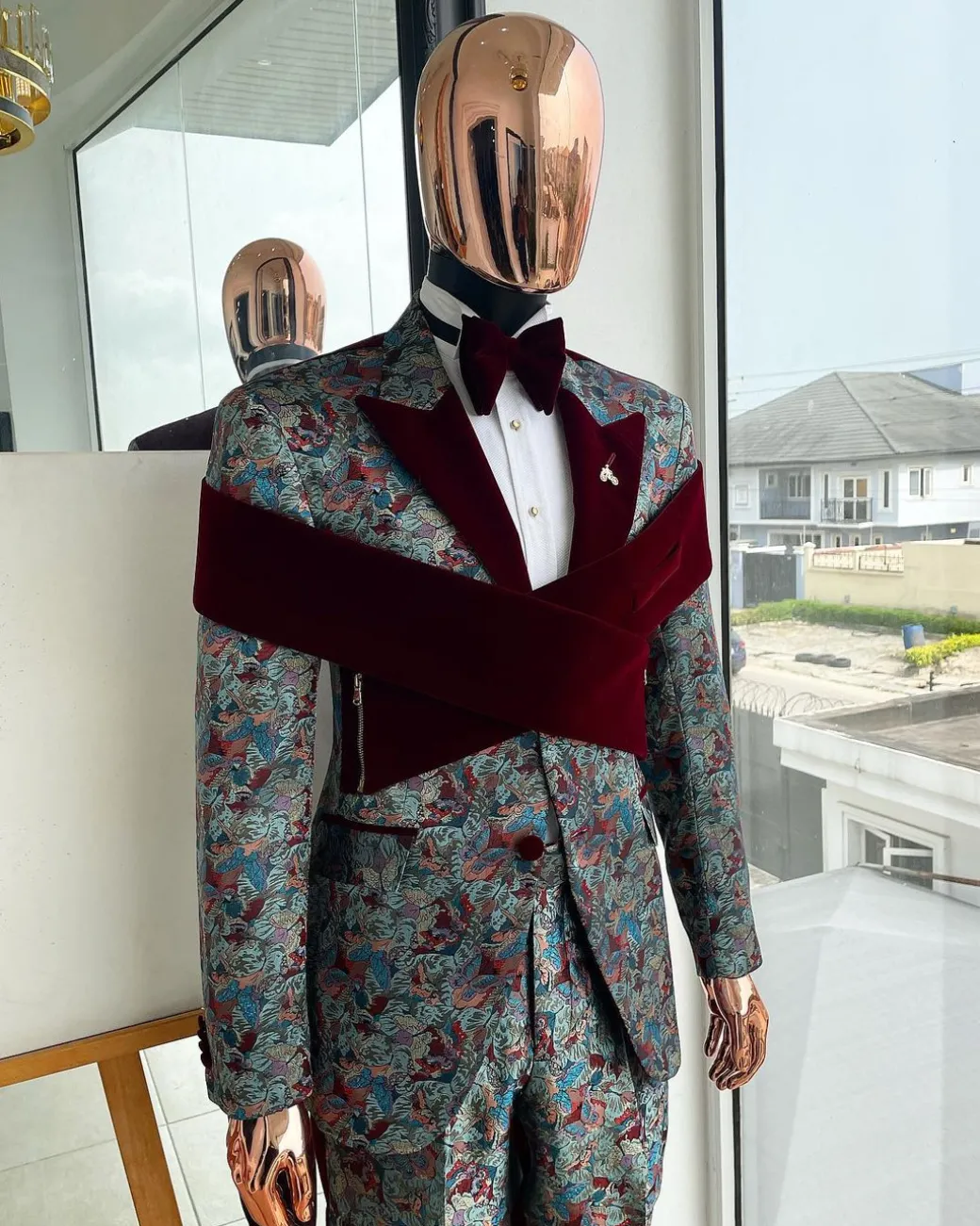 An “octopus” floral paisley tuxedo with intersected mahogany red soaked Italian velvet peak lapel suit