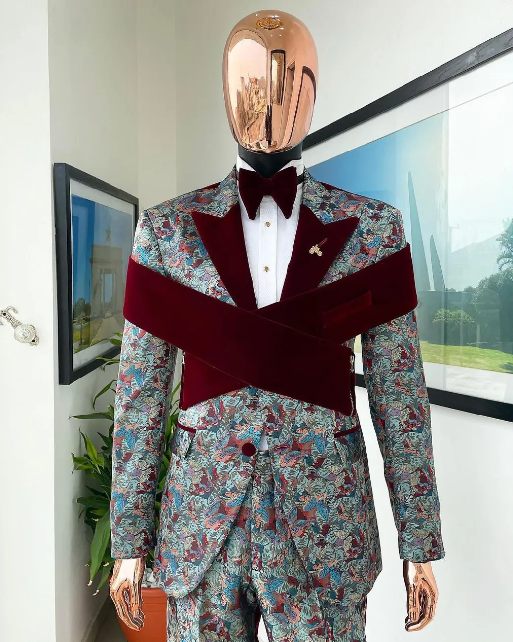 An “octopus” floral paisley tuxedo with intersected mahogany red soaked Italian velvet peak lapel suit