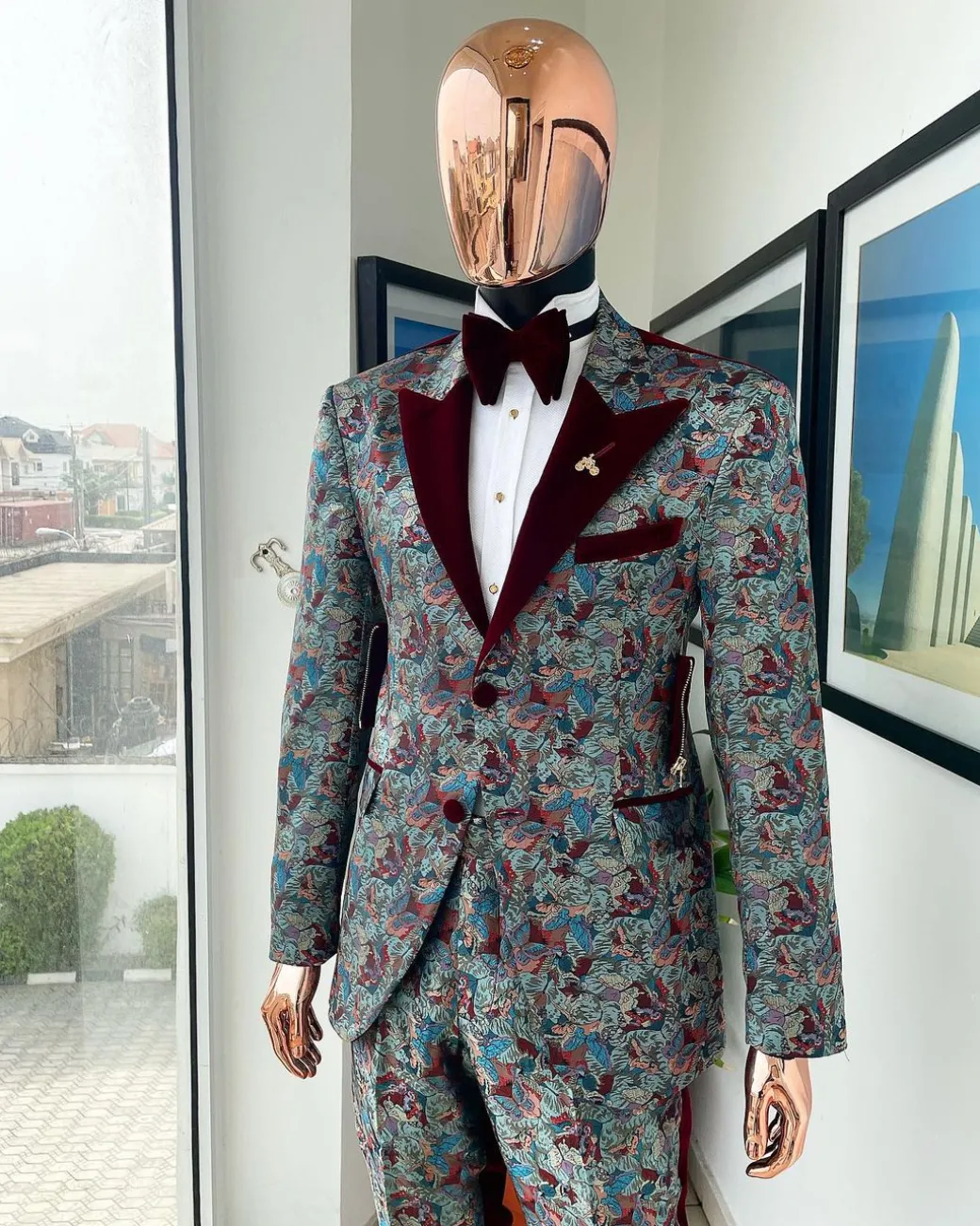 An “octopus” floral paisley tuxedo with intersected mahogany red soaked Italian velvet peak lapel suit